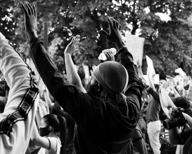 BLM protesters in Washington, DC, raise hands in the air, June 2020.