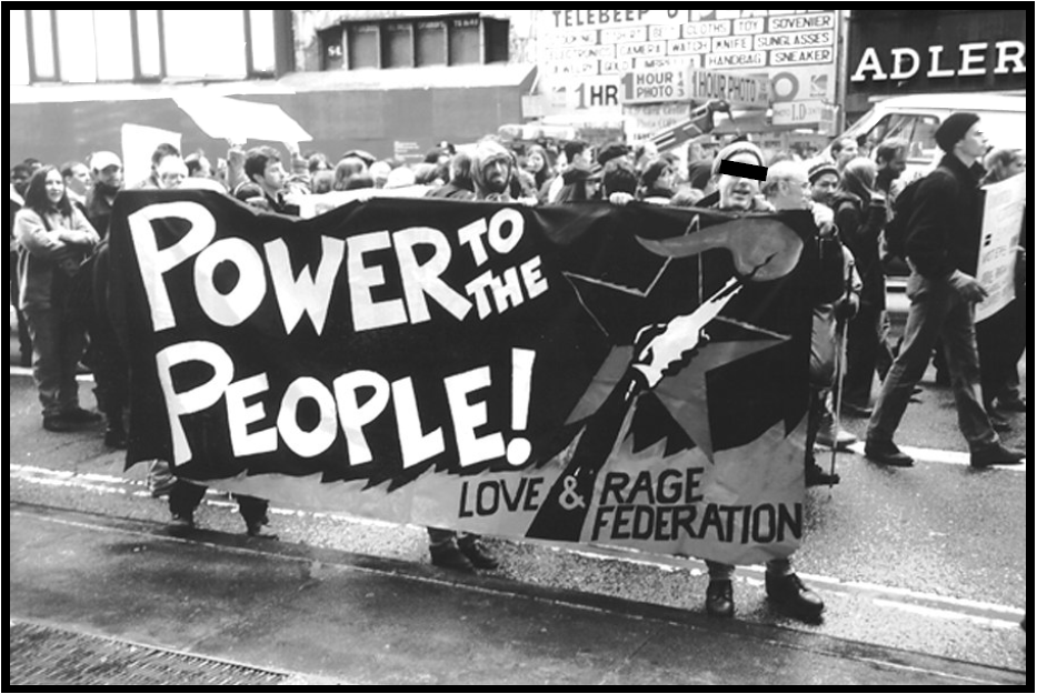 Protestors in march carry banner reading "Power to the People!"