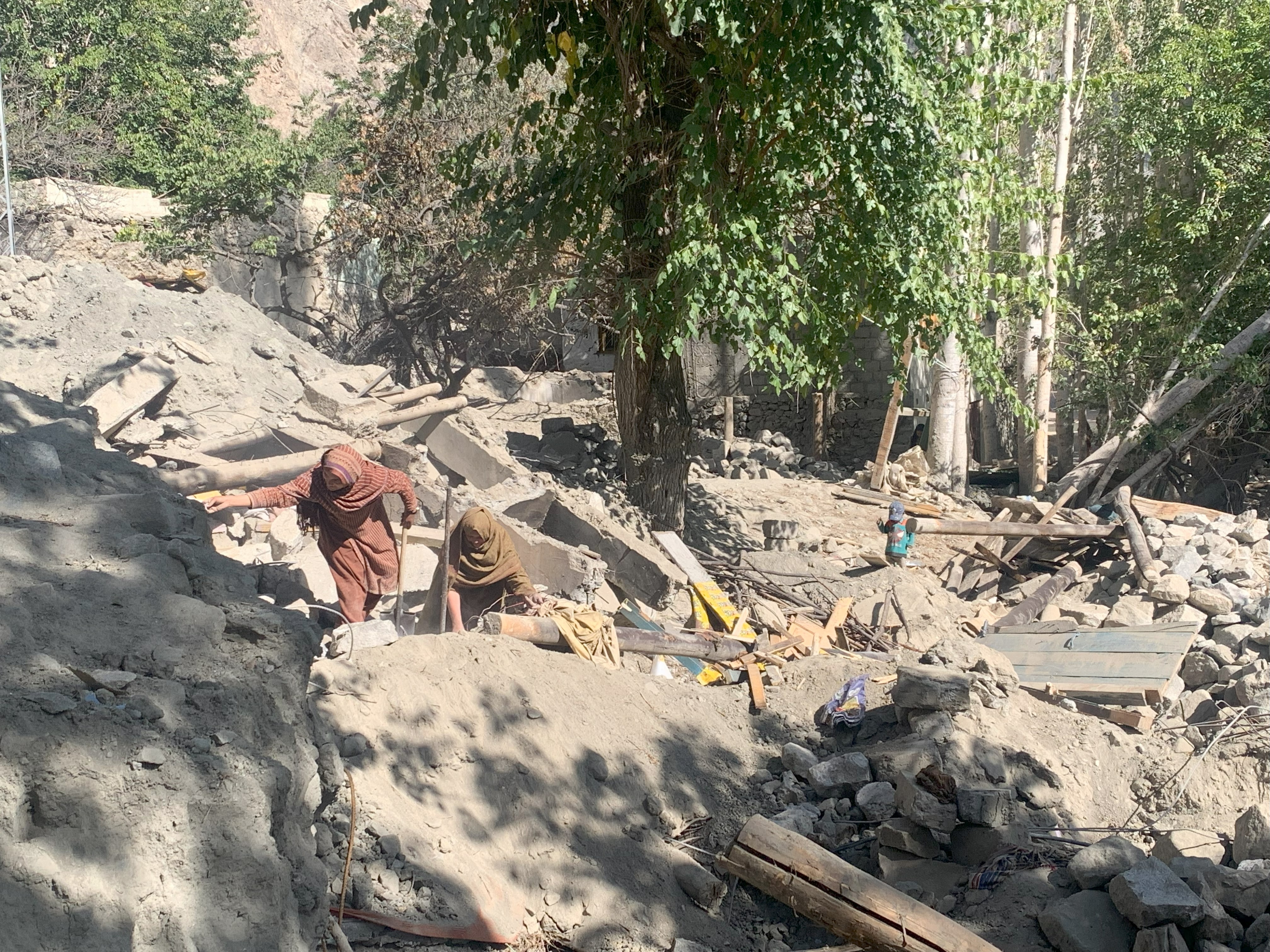 Women searching for documents and essential items after the flash flood destroyed their houses. Location: Gilgit-Baltistan, Pakistan