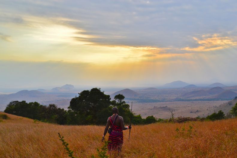 African person walking in a field