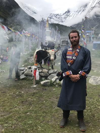 Student stands at ceremony in Nepal