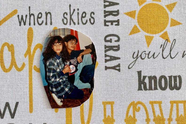 Picture of two siblings on top of fabric