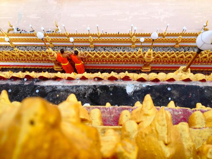 Thai monks seen from the upper level of a temple