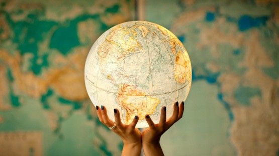 Globe being held in hands