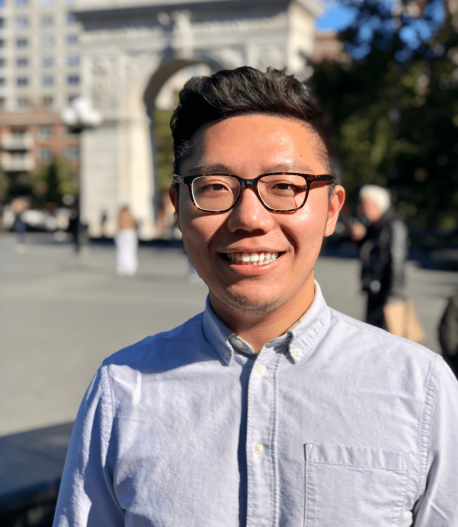 A photo portrait of grad student Zifeng Liu standing outside in NYC's Washington Square with the arch in the background.