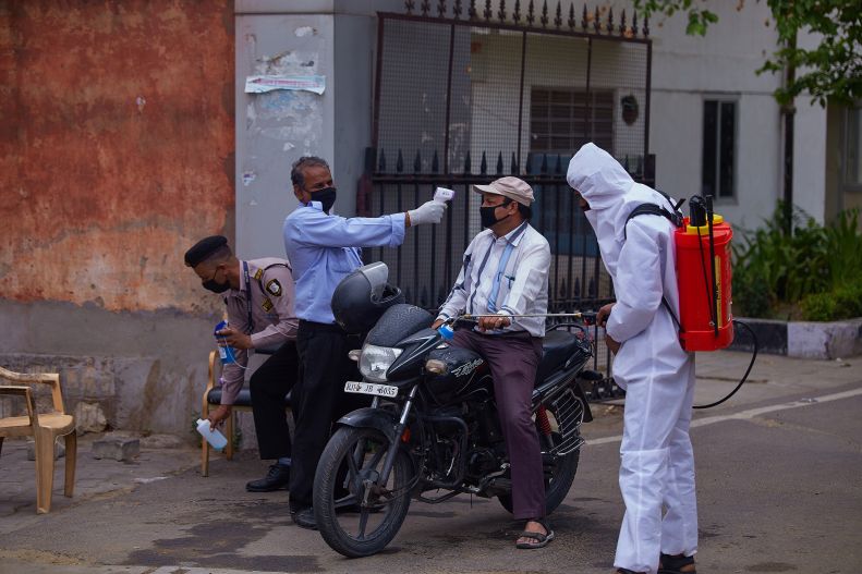 Man on motorcycle stopped for temperature, Jaipur, India