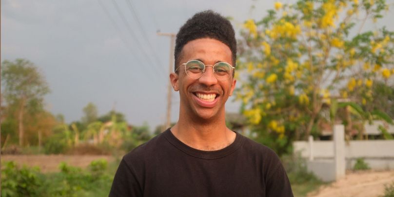 Head shot of Dexter Thomas with trees in background