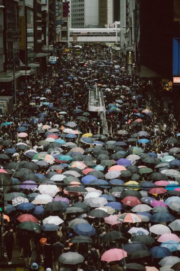 Thousands stand under umbrellas in Hong Kong at public demonstrations