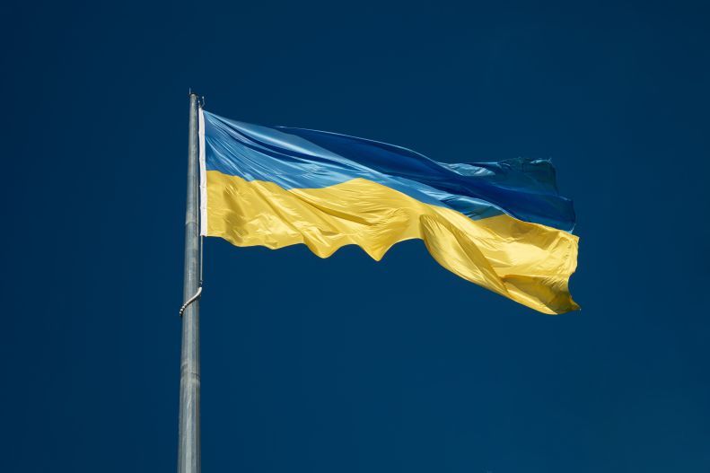 Ukraine flag flying blue sky