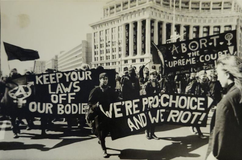 Protestors marching and carrying banners with pro-choice messages