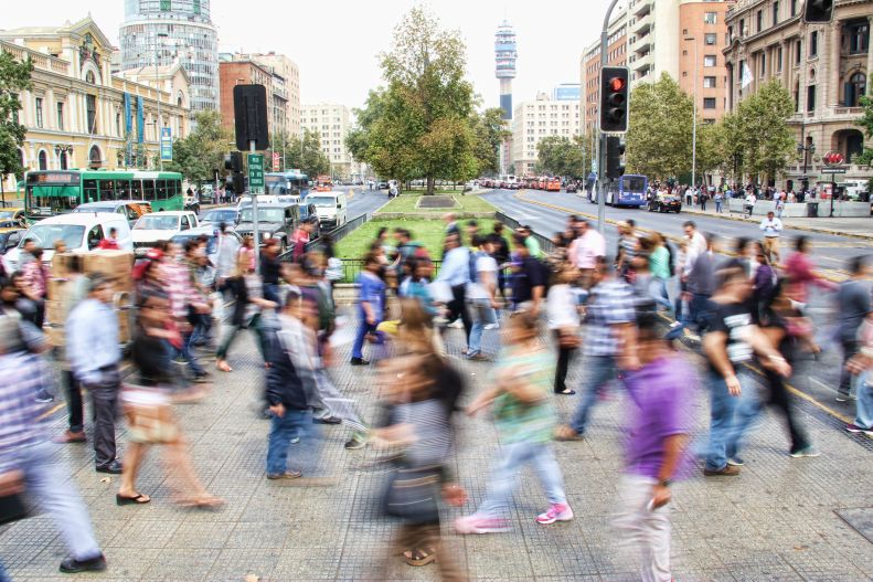 crosswalk image taken in long-exposure with many people crossing a busy road