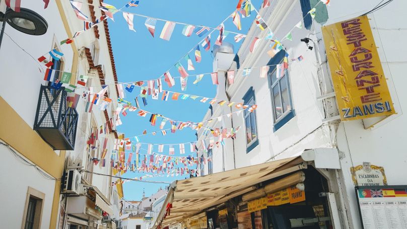 international flags, white buildings, Albufeira, Portugal