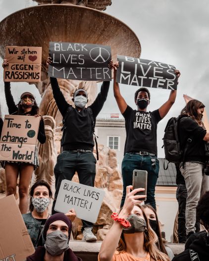 Protestors hold Black Lives Matter signs