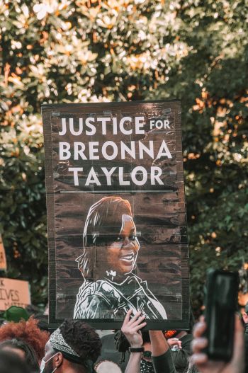 "Justice for Breonna Taylor" protest sign with image of her face