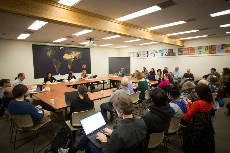group of people with laptops attend a class