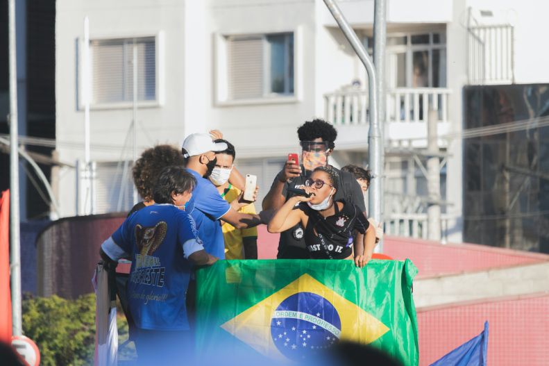 Protesters in Brazil hold signs and flags