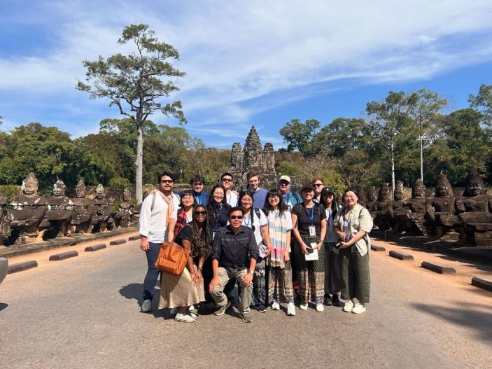 Cambodia winter program 2023 students with archaeology expert Ea Darith at the southern entrance to Angkor.