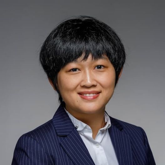 Xian Wang short bob dark hair Asian woman dark blazer white shirt