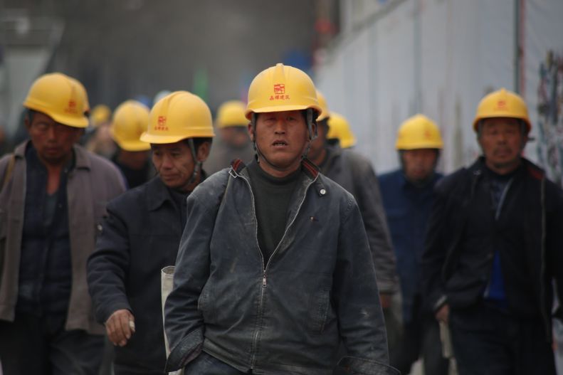 Group of workers in yellow safety helmets in China