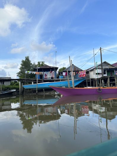 Colorful boats sit in the water in Indonesia