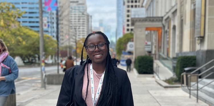 Eliana Amoh smiles for a photo in a city.