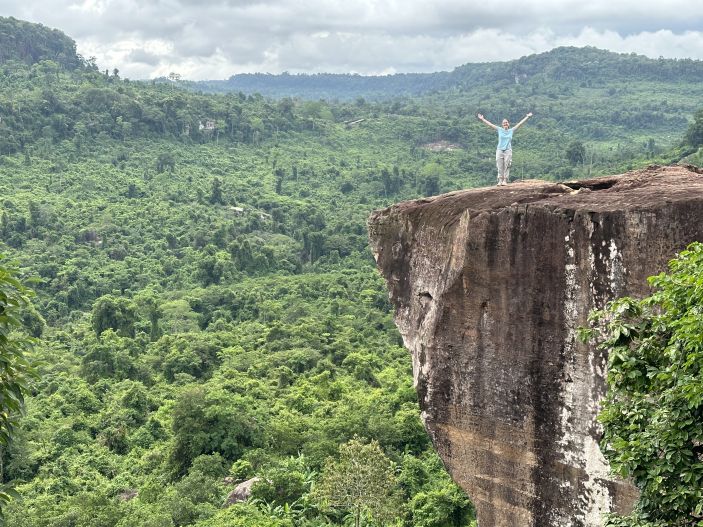 Emma Alexander stands at the top of Phnom Kulen Mountain.