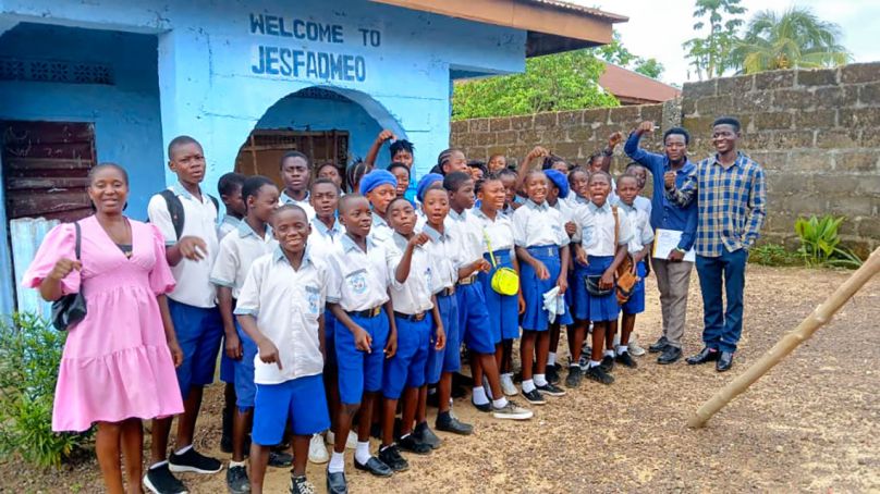 Students from Jasfameo Junior Secondary School in Bo City, Sierra Leone, a participant in the Youth Climate Science Lab and Collaboration Hub project, with Bashiru Koroma, president and CEO of Keep Africa Beautiful Sierra Leone (far right); teacher Emmanuel Mannah; and Alberta Samuels, project coordinator for the hub (far left).