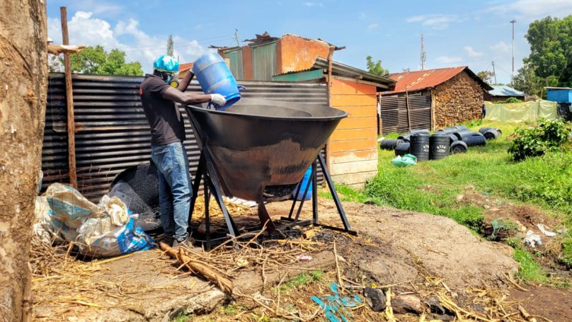 Steven “Governor” Onyango adding dried feces to the Kontiki kiln