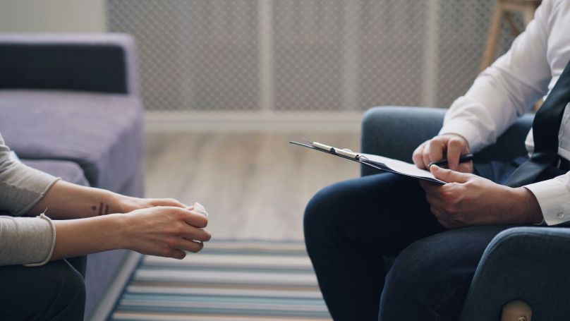 Therapist taking patient notes