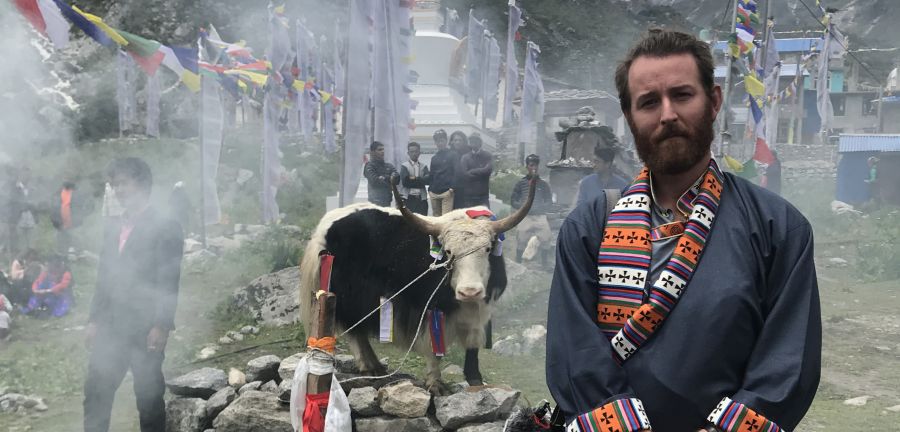 Student stands at ceremony in Nepal