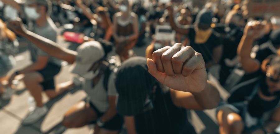 Protesters march with fists in the air