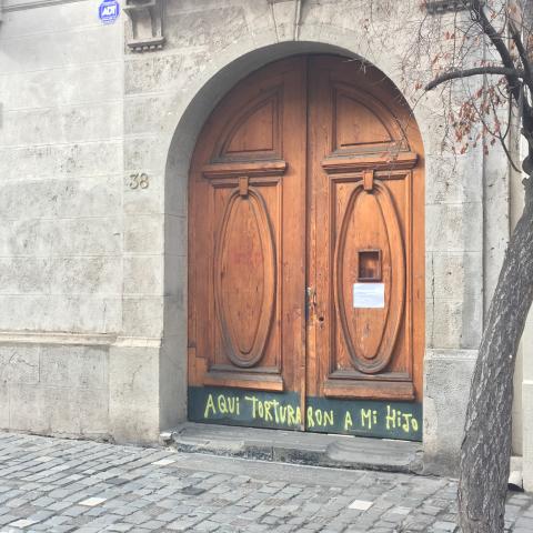 image of door in Santiago, Chile with sign They tortured my son here.