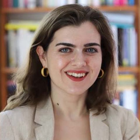 brunette woman in a beige jacket headshot