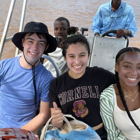 Cornell students smile for a photo on a boat ride in Zambia while studying abroad.