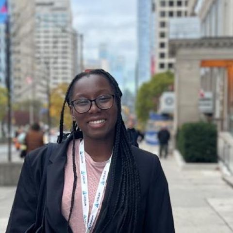 Eliana Amoh smiles for a photo in a city.