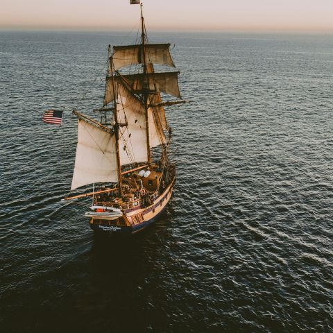 Ship crosses a still ocean