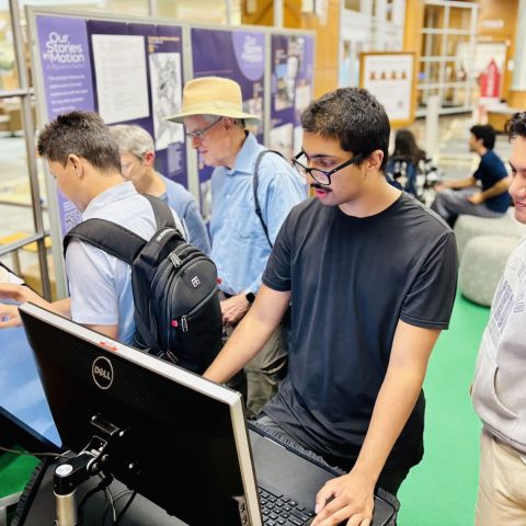 Students enter their migration stories into the "Our Stories in Motion" exhibit.